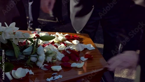 closeup shot of a funeral casket in a hearse or chapel or burial at cemetery photo