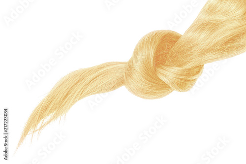 Knot of blond hair on white background
