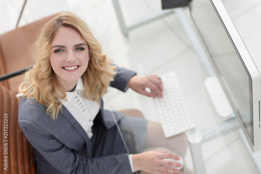 smiling business woman sitting behind a Desk smiling business woman sitting behind a Desk