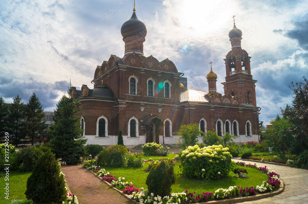 Flowering garden on the landscaped territory of the Savior Transfiguration Church in Tushino. Moscow, Russia.