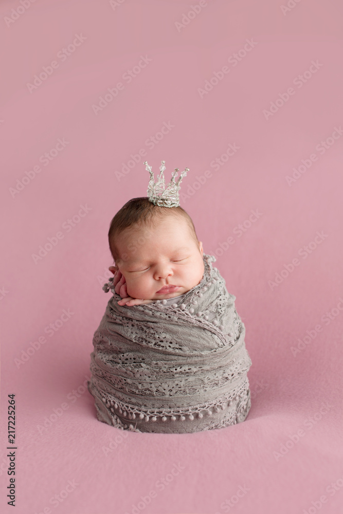 Sleeping newborn girl on a pink background. Little princess with crown.  Photoshoot for the newborn. 7 days from birth. A portrait of a beautiful,  seven day old, newborn baby girl Stock Photo |