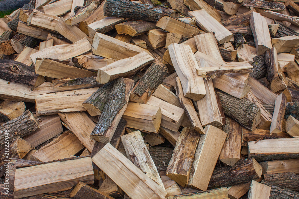 Woodpile of chopped lumber. Pile of wood logs. Stacked firewood timber Woodpile of chopped lumber. Pile of wood logs. Stacked firewood timber