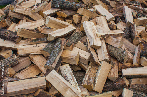 Woodpile of chopped lumber. Pile of wood logs. Stacked firewood timber