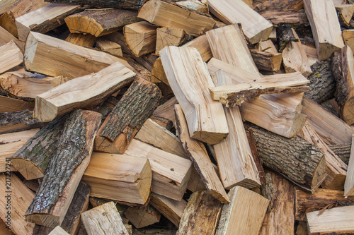 Woodpile of chopped lumber. Pile of wood logs. Stacked firewood timber