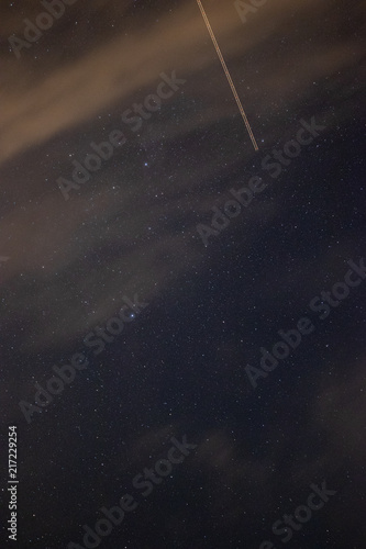 Astrophotography on a cloudy night interrupted by a plane