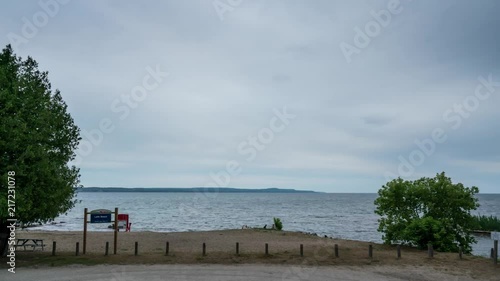 A cloudy summer morning time lapse on Leith beach just outside of Owen Sound in the Grey County, Meaford areas of Southern Ontario, Canada. photo