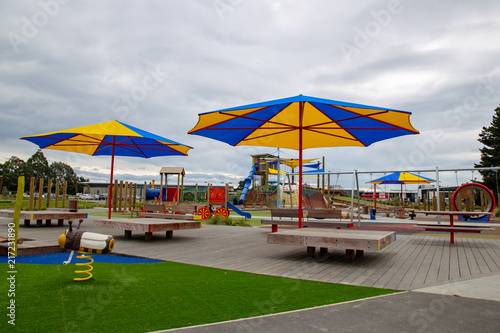 Blue and Yellow umbrellas provide shade in the colorful playground park in Rolleston