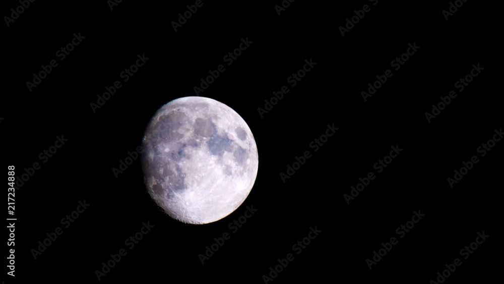 A waxing gibbous moon crosses from left to right in a time lapse. A waxing gibbous moon crosses from left to right in a time lapse.