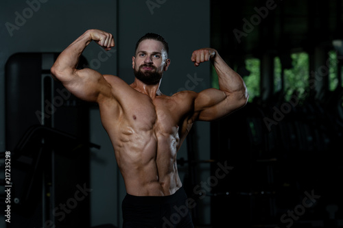 Bodybuilder Flexing Muscles © Jale Ibrak