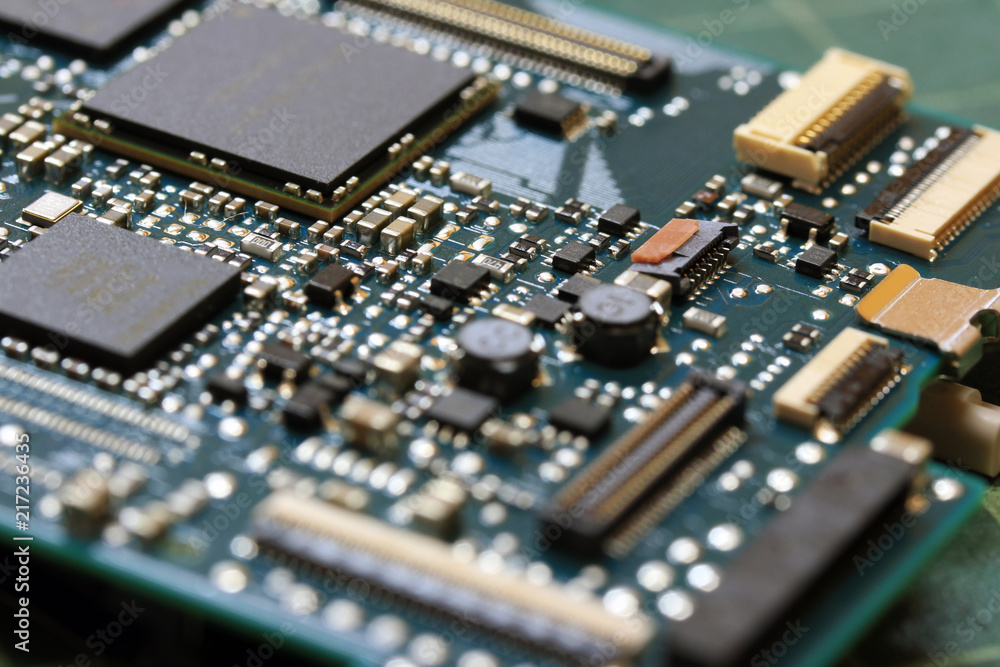Electronics background technology close up of the green kit circuit board. Application Specific Integrated Circuit.