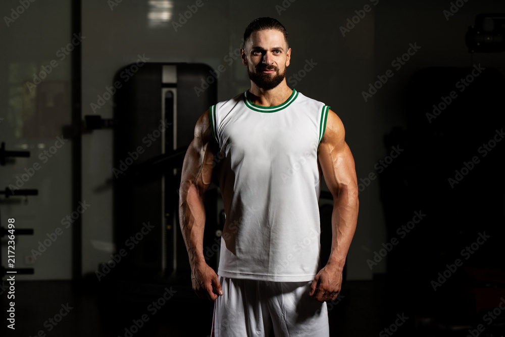Muscular Man In Sports Outfit In Fitness Center Muscular Man In Sports Outfit In Fitness Center