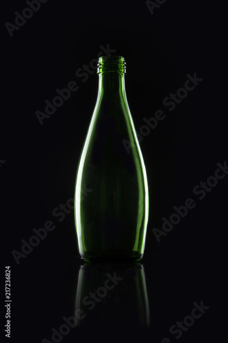 green soda bottle on the black