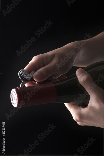 woman hand hold a wine bottle on the black © dohee