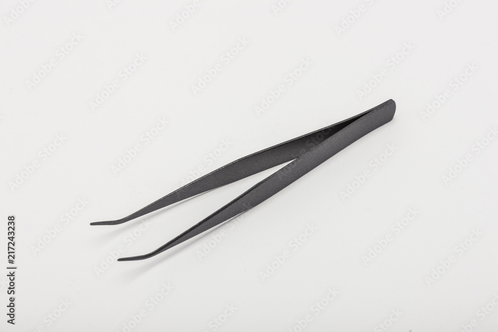 titanium tweezers(pincette) on the white background. titanium tweezers(pincette) on the white background.