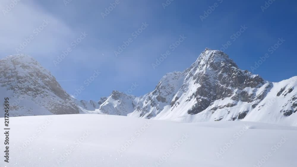 Clouds Rolling By in the Snow Covered Peaks of the Swiss Alps Clouds Rolling By in the Snow Covered Peaks of the Swiss Alps
