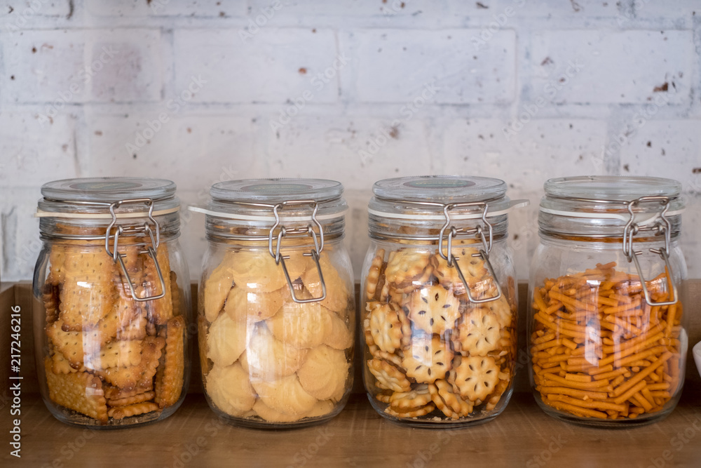 Snack and Biscuit in Kitchen Canisters & Jars with brick wall background Snack and Biscuit in Kitchen Canisters & Jars with brick wall background
