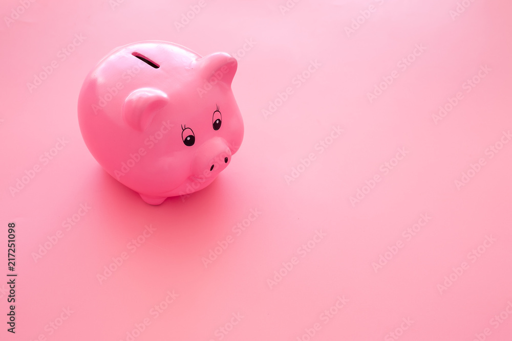 Piggy bank. Moneybox in shape of pig on pink background copy space