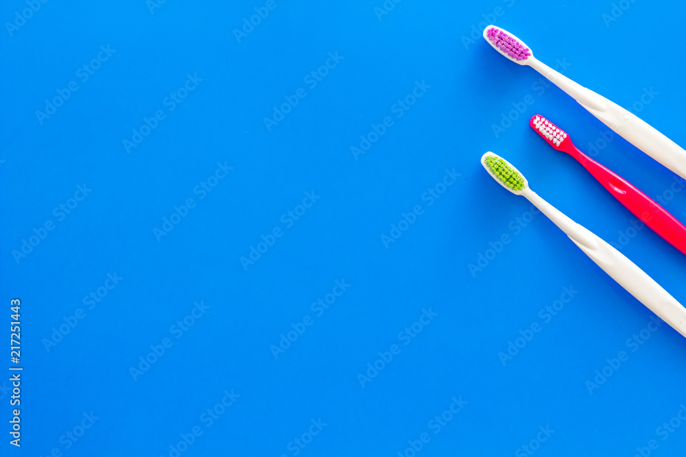 Clean teeth. Toothbrushes on blue background top view copy space Clean teeth. Toothbrushes on blue background top view copy space