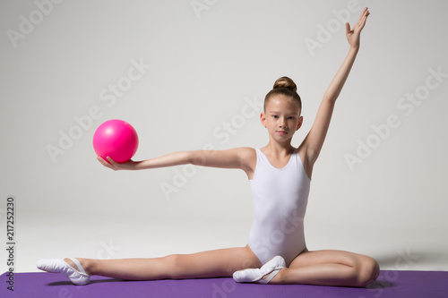 Young gymnast doing an exercise with a ball. Children's sports. Children's gymnastics. Girl