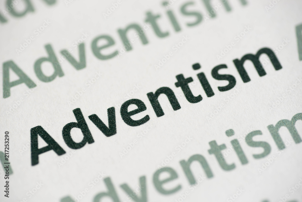 word Adventism printed on paper macro