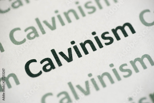 word Calvinism  printed on paper macro photo