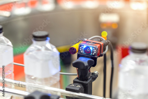 Microscan, MicroHAWK and MicroVISION includes the barcode reading technology for the production line of plastic bottles on a conveyor belt in mineral water factory.