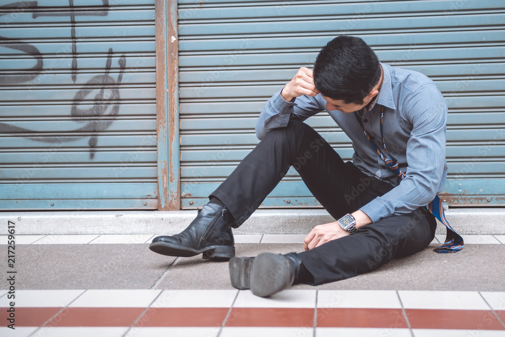 Unemployed man sitting on the street Unemployed man sitting on the street
