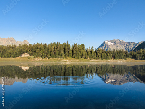 Alpine lake and forest, mountain landscape in Valtellina. Valmalneco