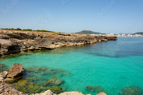 Fototapeta Naklejka Na Ścianę i Meble -  View over the clear turquoise waters of the Mediterranean to the beach of Cala Millor on the Spanish Mediterranean island Mallocra