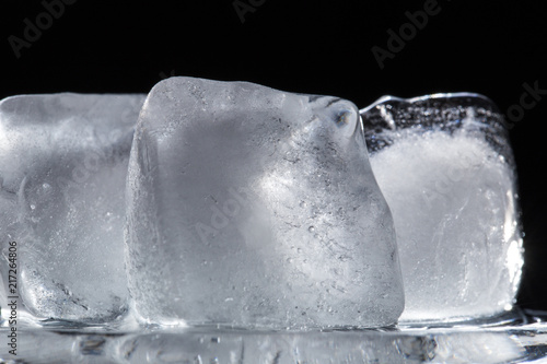 texture of three ice cubes on a black background close-up