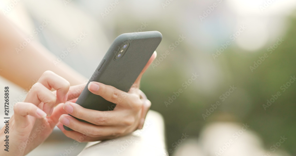 Close up of woman use of mobile phone in the evening