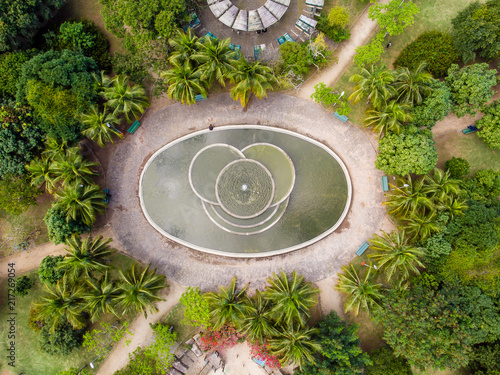 aerial view of man made pond with fountain in park in Barra da tijuca, Rio de janeiro. Drone pov shows geometric shapes and patterns, including circles and elipses