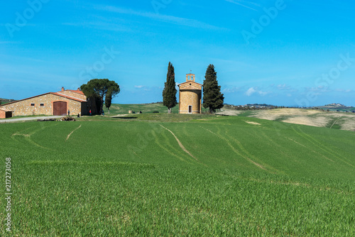 Tuscany landscape with the little chapel of Madonna di Vitaleta, San Quirico d'Orcia, Italy photo