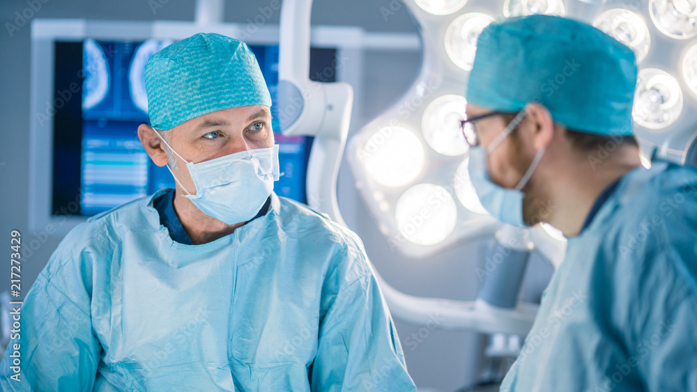 Portrait Shot of a Diverse Team of Professional Surgeon and Assistants Performing Invasive Surgery on a Patient in the Hospital Operating Room. Surgeons Have Active Discussion Trying to Save Life Portrait Shot of a Diverse Team of Professional Surgeon and Assistants Performing Invasive Surgery on a Patient in the Hospital Operating Room. Surgeons Have Active Discussion Trying to Save Life
