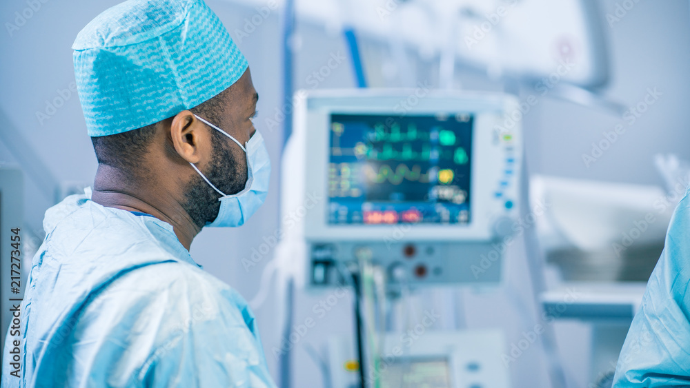 Diverse Team of Professional Surgeon and Assistants Performing Invasive Surgery on a Patient in the Hospital Operating Room. Surgeons Have Active Discussion Trying to Save Life of a Patient. Diverse Team of Professional Surgeon and Assistants Performing Invasive Surgery on a Patient in the Hospital Operating Room. Surgeons Have Active Discussion Trying to Save Life of a Patient.