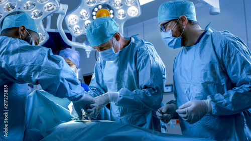 Картината върху платно In the Hospital Operating Room Diverse Team of Professional Surgeons and Nurses Suture Wound after Successful Surgery