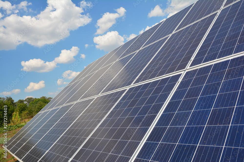 Solar panels surface background with beautiful clouds sky. View on solar panels. Innovation concept. Solar panels surface background with beautiful clouds sky. View on solar panels. Innovation concept.