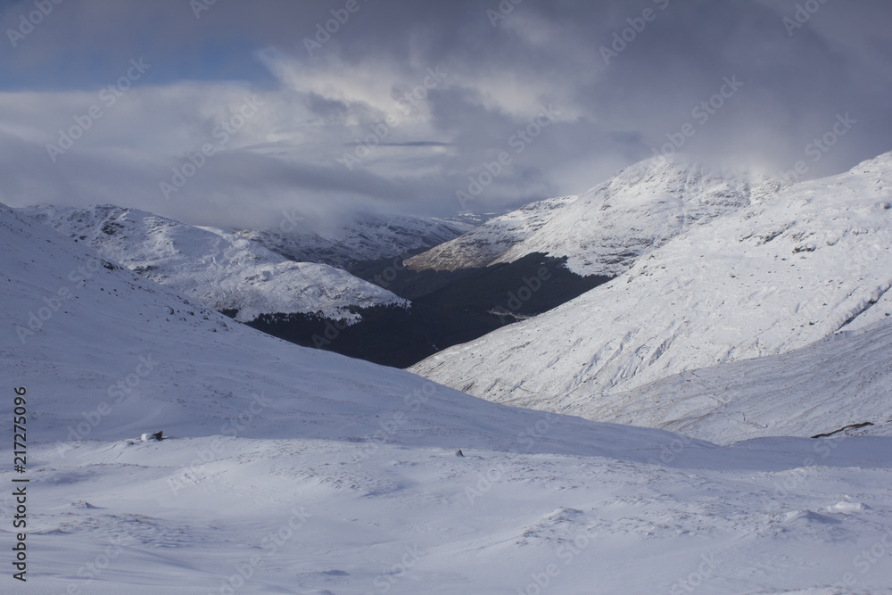 A panoramic view of the snow caped Scottish Munro mountain in winter