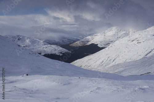 A panoramic view of the snow caped Scottish Munro mountain in winter