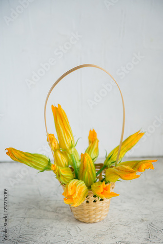 Edible flowers, zucchini blossoms on brown natural background photo