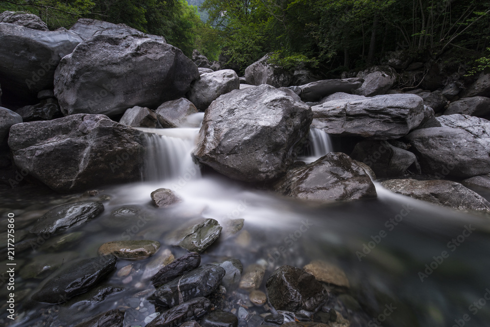 Beautiful waterfall scene with clear water flowing between rocks Beautiful waterfall scene with clear water flowing between rocks