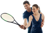 Woman learns playing tennis with help of a male coach. Joy of physical activity, sport games, skills.