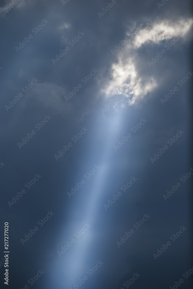 Fototapeta premium Ray of the sun through storm clouds
