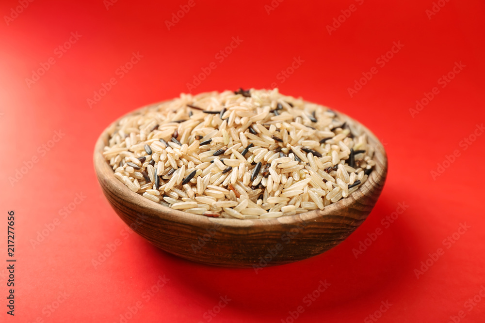 Bowl with raw rice on color background Bowl with raw rice on color background