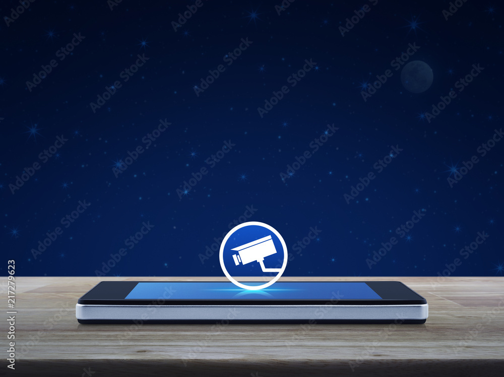 cctv camera icon on modern smart mobile phone screen on wooden table over fantasy night sky and moon, Business security and safety online concept cctv camera icon on modern smart mobile phone screen on wooden table over fantasy night sky and moon, Business security and safety online concept