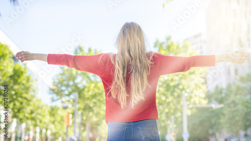 Happy blonde girl relaxing in the city