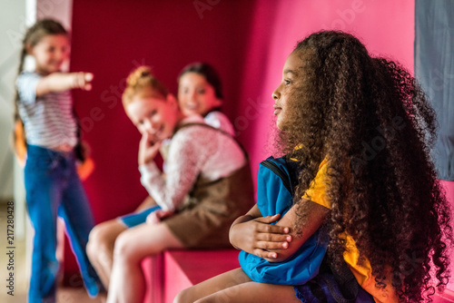 Fotografía schoolgirls bullying on their african american classmate at school