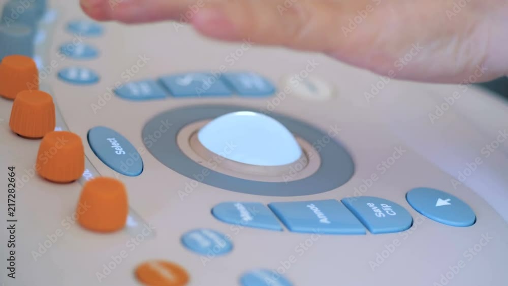 Close up of a hand manipulating an ultrasound console Close up of a hand manipulating an ultrasound console