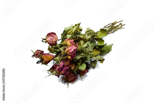 Top view of dried red rose and leaf on white background
