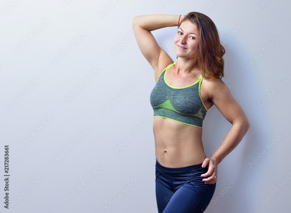Fototapeta premium Beautiful female fitness trainer isolated on the white background.